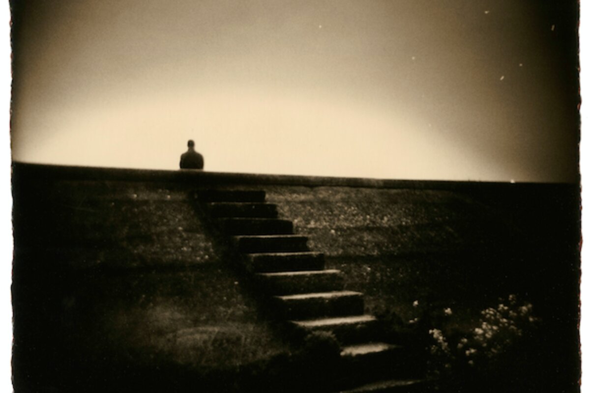 A contemplative sepia-toned photograph from Masao Yamamoto's Nakazora series